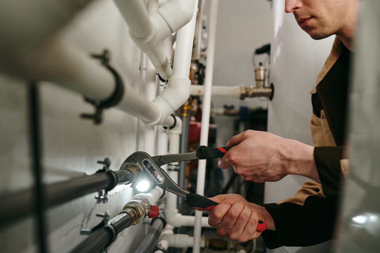 Plumbers maintaining commercial plumbing pipes in Johnstown