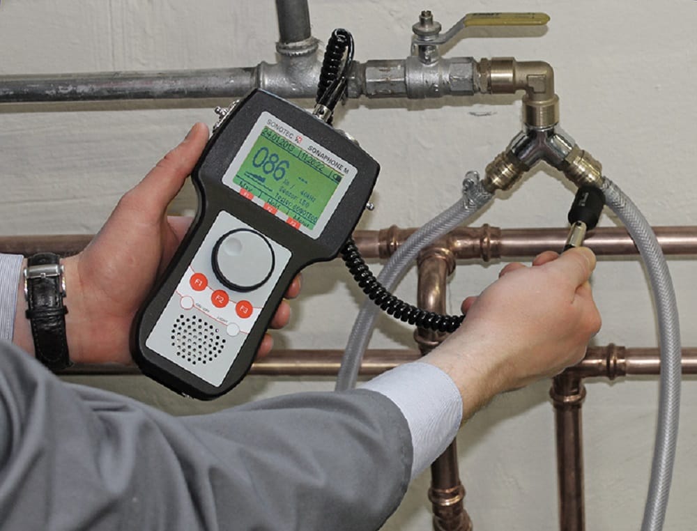 Plumber testing pipes with electronic leak detection equipment in Johnstown
