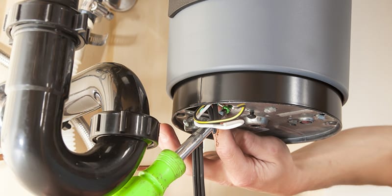 Technician repairing the heating element of a water heater in Johnstown